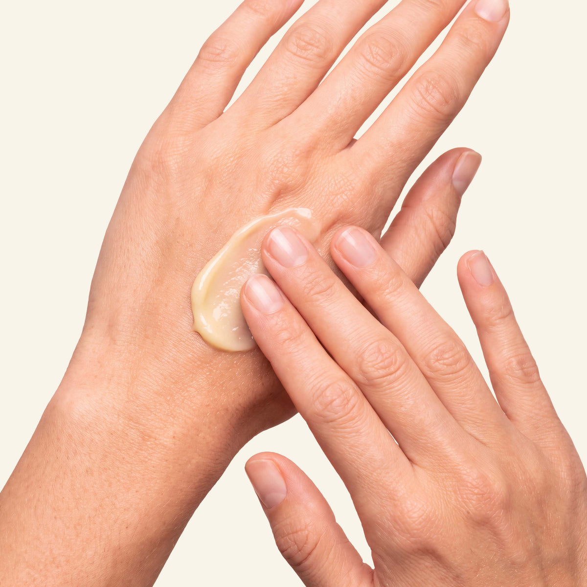 Kopa Moisturizing Salve being rubbed into the back of a hand