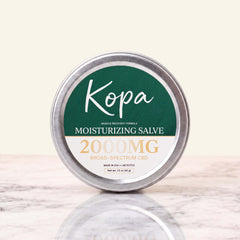 Kopa Moisturizing Salve 2000mg CBD in a closed round metal tin with a dark green label