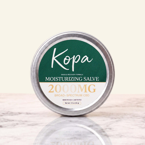 Kopa Moisturizing Salve 2000mg CBD in a closed round metal tin with a dark green label